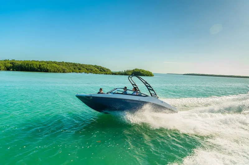 Slide: The Image of Yamaha 195S 2024 on turquoise water with lush green landscape in the background. - 36
