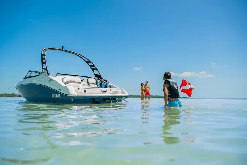 Slide: The Image of A 2024 Yamaha 195S boat in shallow water with people nearby. - 22
