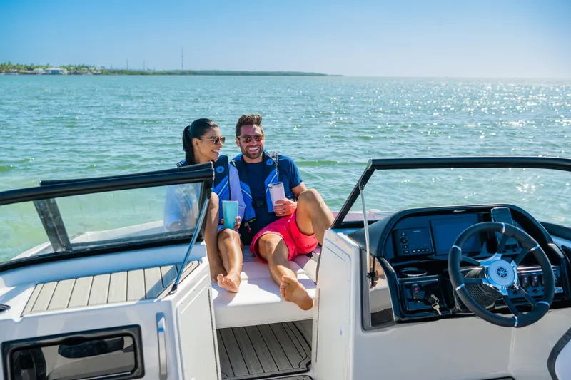 Slide: The Image of A couple relaxes on a Yamaha 195S boat, floating on calm waters. - 16