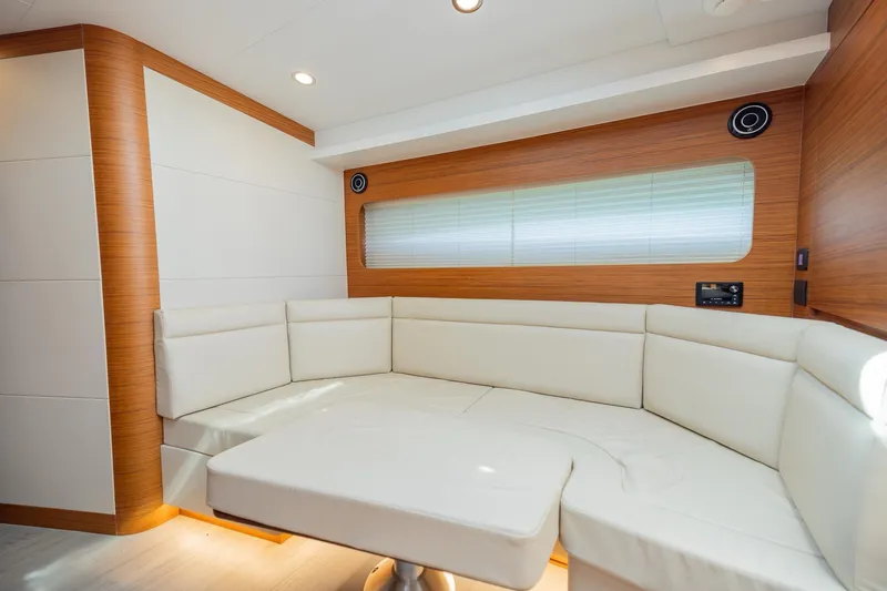 Slide: The Image of Luxurious interior of 2022 Bertram 50 Sport yacht with elegant white seating and wood accents. - 22