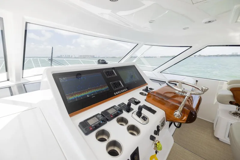 Slide: The Image of Interior helm of 2022 Bertram 50 Sport yacht with advanced navigation controls. - 18
