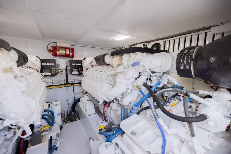 Slide: The Image of Engine room of 2022 Bertram 50 Sport yacht with MAN engines and fire extinguisher. - 28