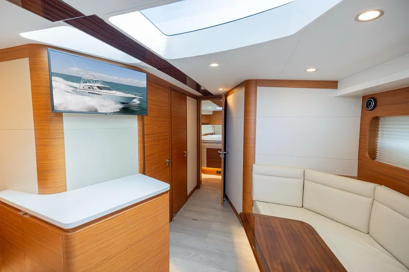 Slide: The Image of Luxurious interior of 2022 Bertram 50 Sport yacht with modern wood finishes and seating. - 19