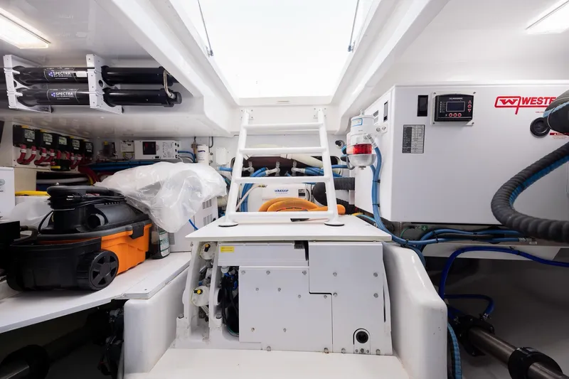 Slide: The Image of Engine room of 2022 Bertram 50 Sport yacht, featuring equipment and storage. - 27