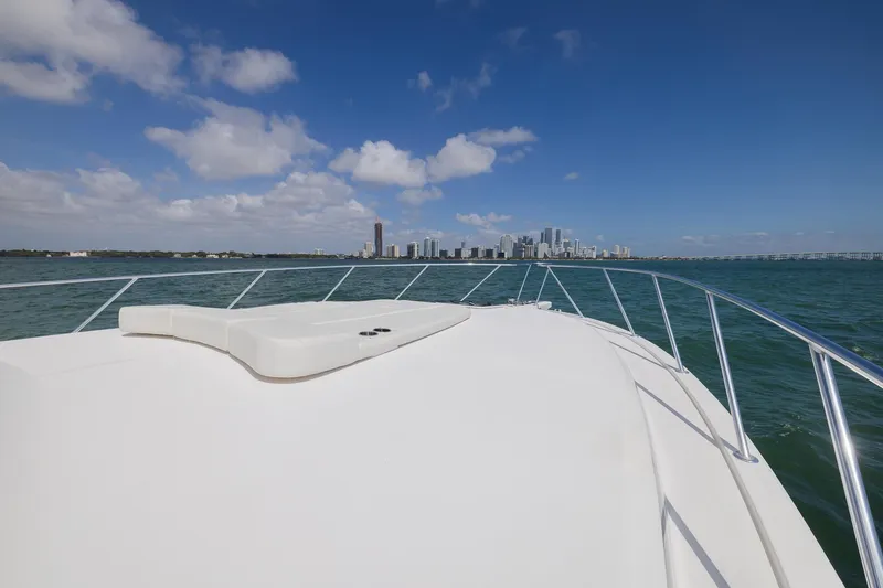 Slide: The Image of 2022 Bertram 50 Sport yacht cruising with city skyline in the background. - 6