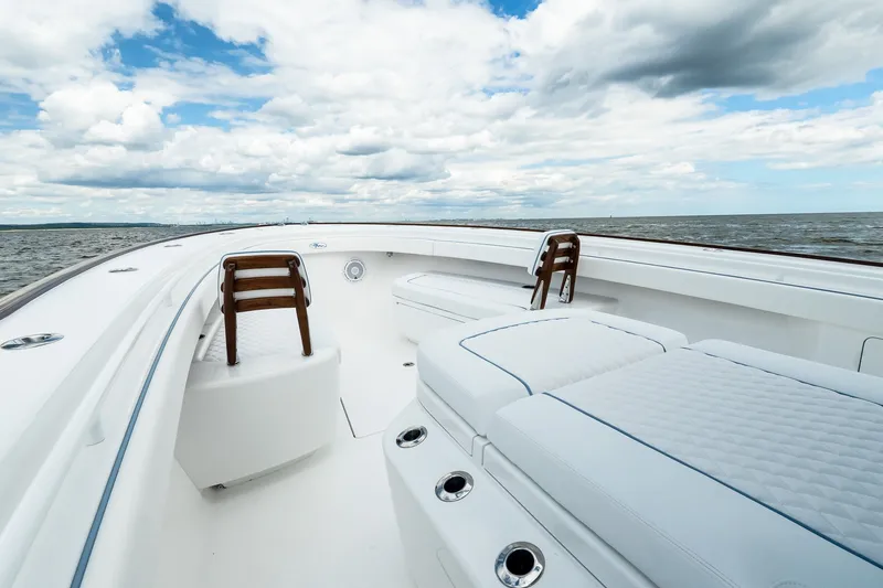 Slide: The Image of Luxurious 2027 Valhalla V-37 yacht interior with plush seating, ocean view, and cloudy sky. - 50