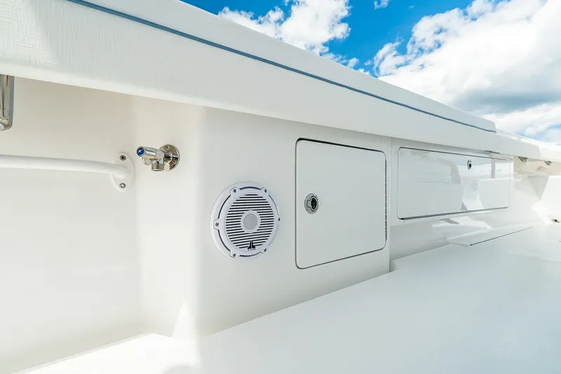 Slide: The Image of Valhalla V-37 2027 boat deck with storage compartments and speaker under blue sky. - 47