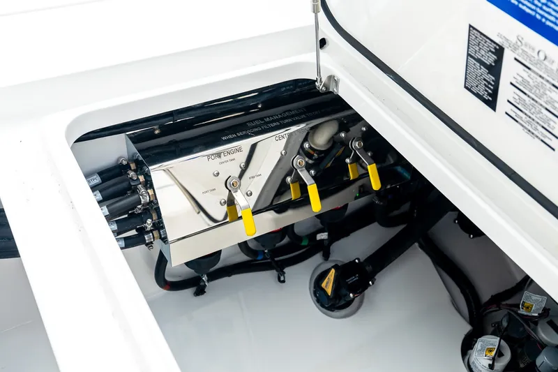 Slide: The Image of Engine compartment of 2027 Valhalla V-37 boat with control levers and wiring. - 16