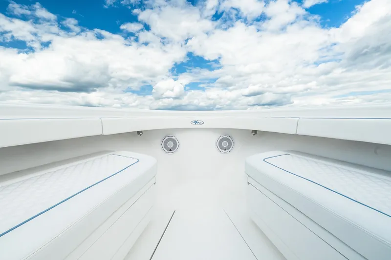 Slide: The Image of 2027 Valhalla V-37 boat interior with white seating and blue sky background. - 53
