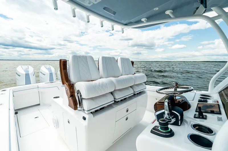 Slide: The Image of Luxurious 2027 Valhalla V-37 boat interior with plush seating and advanced controls on open water. - 25