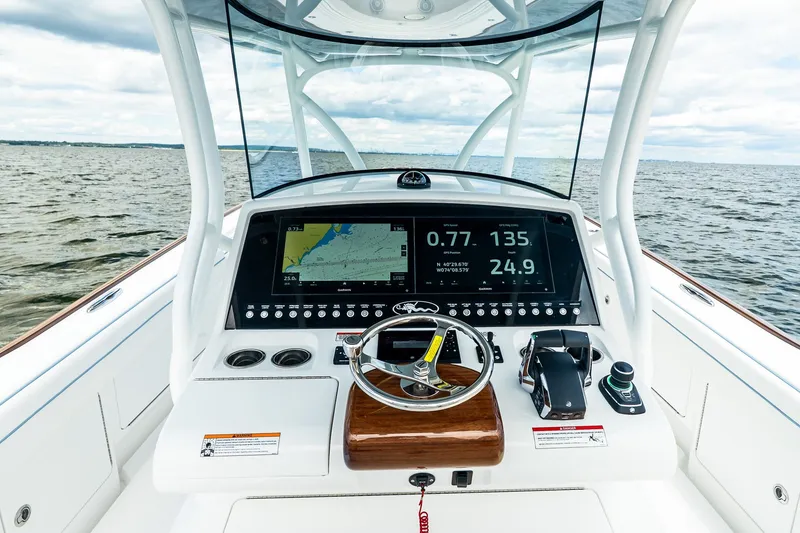 Slide: The Image of Valhalla V-37 2027 boat dashboard with navigation screens on open water. - 31