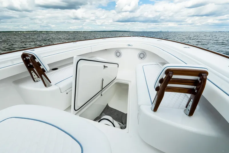 Slide: The Image of Luxurious 2027 Valhalla V-37 boat interior with open storage, white seating, and ocean view. - 54
