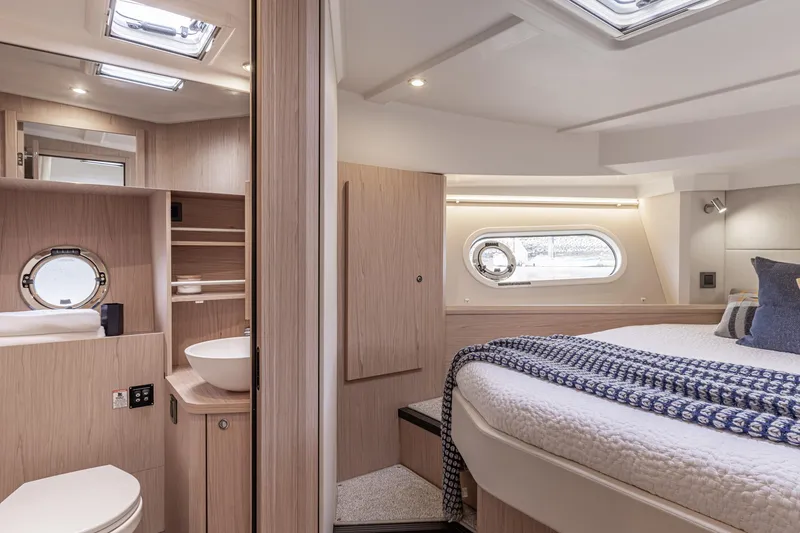 Slide: The Image of Luxurious interior of 2026 Beneteau Swift Trawler 41 Fly, featuring cozy bedroom and modern bathroom. - 12