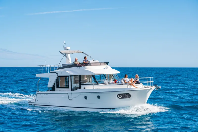 Slide: The Image of 2026 Beneteau Swift Trawler 41 Fly cruising on open sea under clear blue sky. - 26
