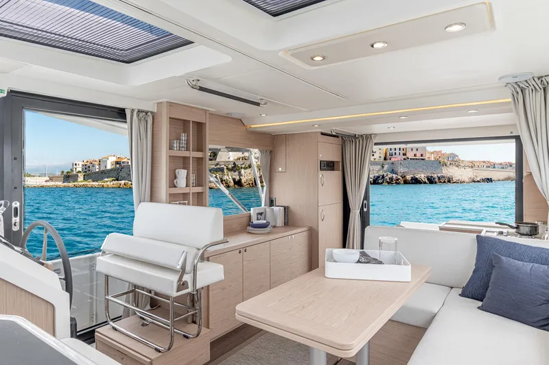 Slide: The Image of Interior of 2026 Beneteau Swift Trawler 41 Fly with ocean view and modern furnishings. - 16