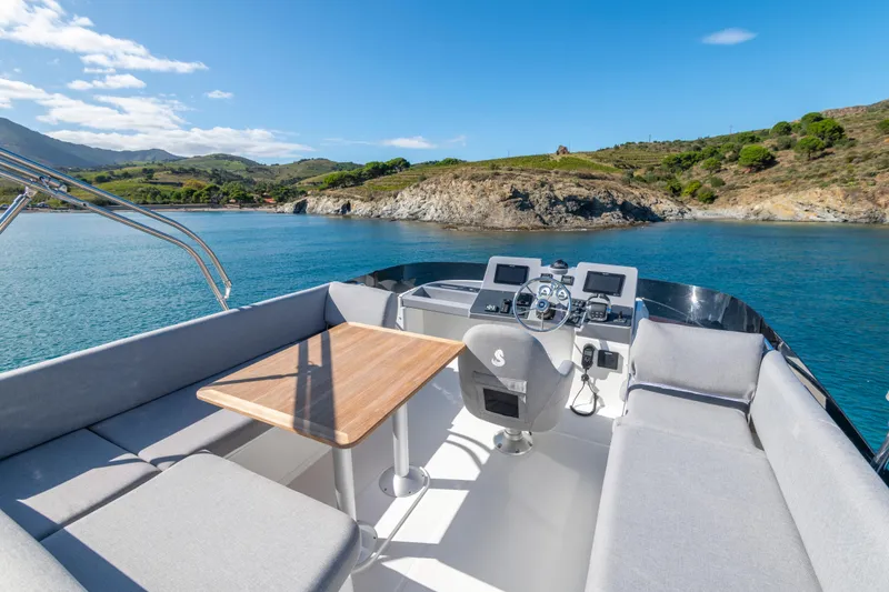 Slide: The Image of Flybridge view of 2026 Beneteau Swift Trawler 41 Fly, overlooking serene coastal waters. - 24