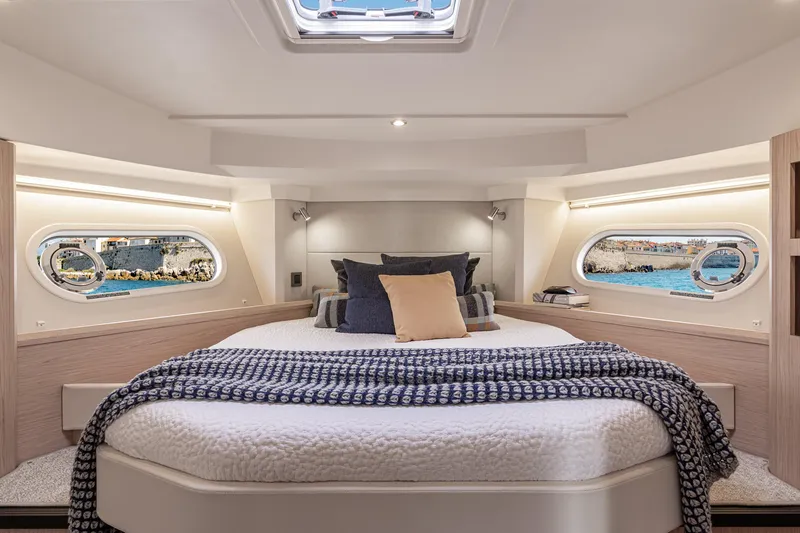Slide: The Image of Luxurious cabin interior of 2026 Beneteau Swift Trawler 41 Fly with scenic window views. - 11