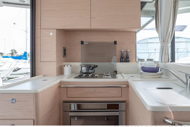 Slide: The Image of Modern kitchen interior of 2026 Beneteau Swift Trawler 41 Fly yacht, featuring sleek cabinetry and appliances. - 8