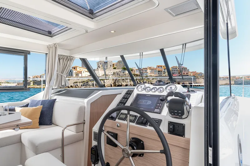 Slide: The Image of Interior view of 2026 Beneteau Swift Trawler 41 Fly, featuring helm and seating area. - 18