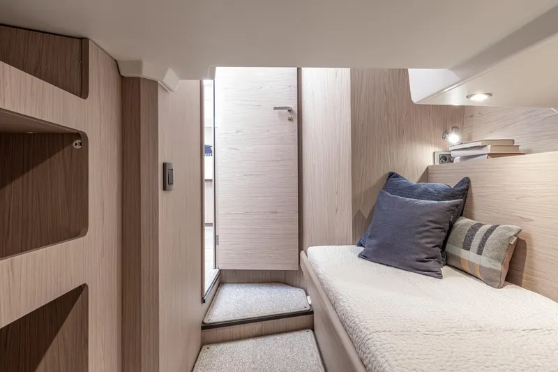 Slide: The Image of Interior cabin of 2026 Beneteau Swift Trawler 41 Fly, featuring cozy bedding and modern design. - 13