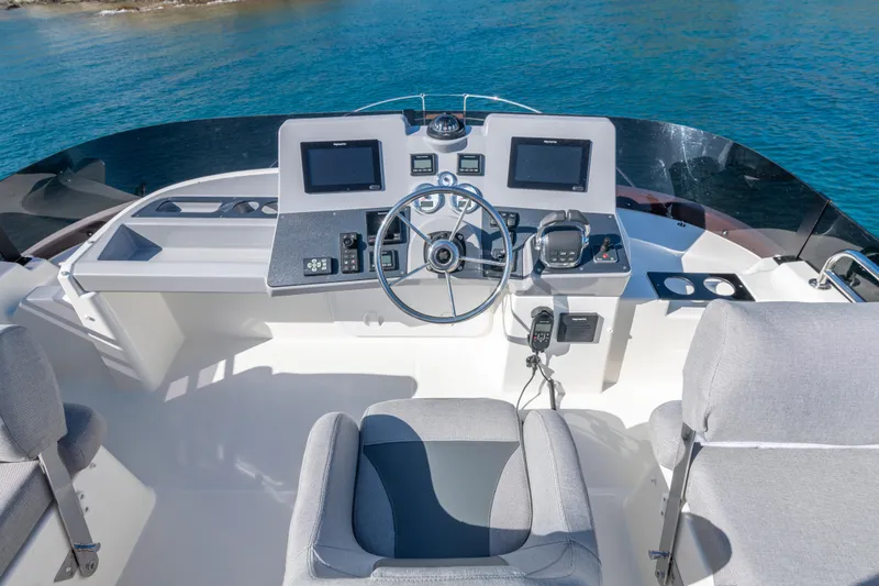 Slide: The Image of 2026 Beneteau Swift Trawler 41 Fly helm with modern navigation equipment and comfortable seating. - 21
