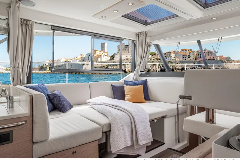 Slide: The Image of Luxurious interior of 2026 Beneteau Swift Trawler 41 Fly with scenic coastal view. - 10