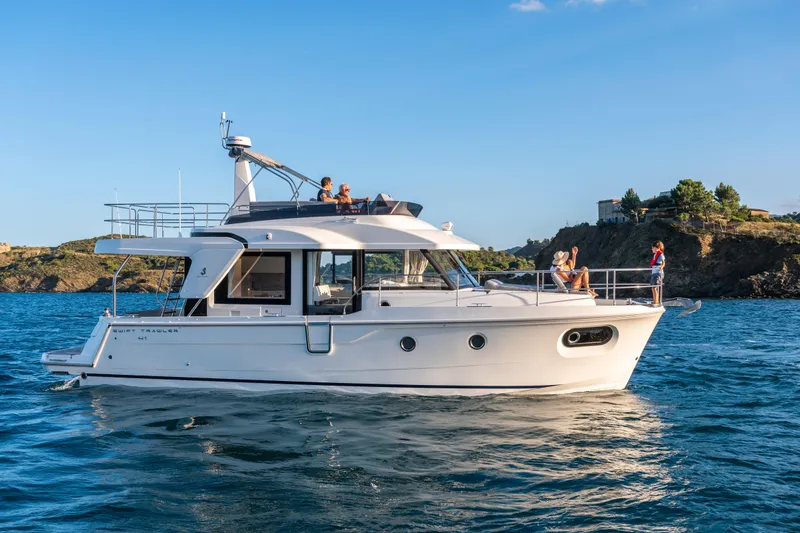 Slide: The Image of 2026 Beneteau Swift Trawler 41 Fly cruising on scenic blue waters. - 27