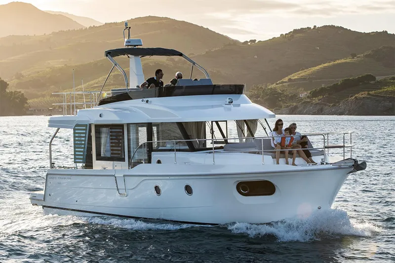 The Image of Manufacturer Provided Image: 2026 Beneteau Swift Trawler 41 Fly cruising on scenic waters at sunset. - 0