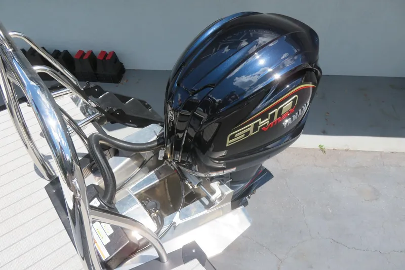 Slide: The Image of Outboard motor on 2027 Avalon LSZ Versatile Rear Bench boat, showcasing sleek design and chrome details. - 39