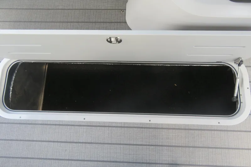 Slide: The Image of Open storage compartment on 2027 Avalon LSZ Versatile Rear Bench boat. - 34