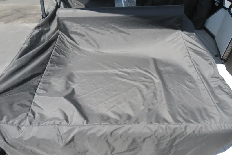 Slide: The Image of Covered rear bench of 2027 Avalon LSZ Versatile boat, showcasing protective fabric. - 45