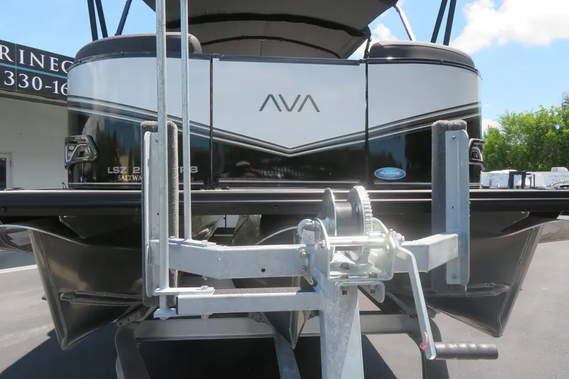 Slide: The Image of 2027 Avalon LSZ Versatile Rear Bench boat on trailer, showcasing sleek design and modern features. - 7