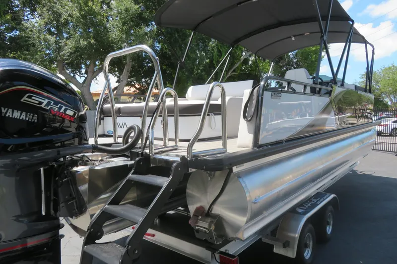 Slide: The Image of 2027 Avalon LSZ Versatile Rear Bench pontoon boat with Yamaha engine, parked on trailer. - 4