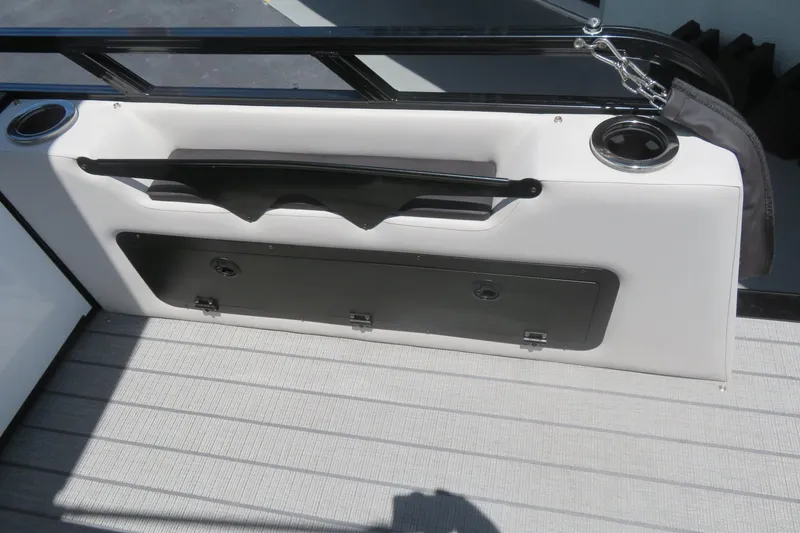Slide: The Image of 2027 Avalon LSZ Versatile Rear Bench with storage compartment and cup holders on a boat deck. - 17