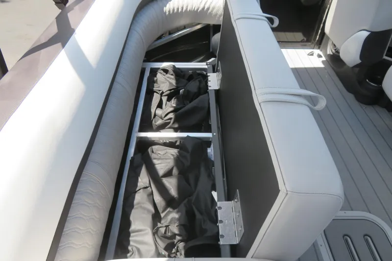 Slide: The Image of 2027 Avalon LSZ Versatile Rear Bench with open storage compartments on a boat deck. - 27