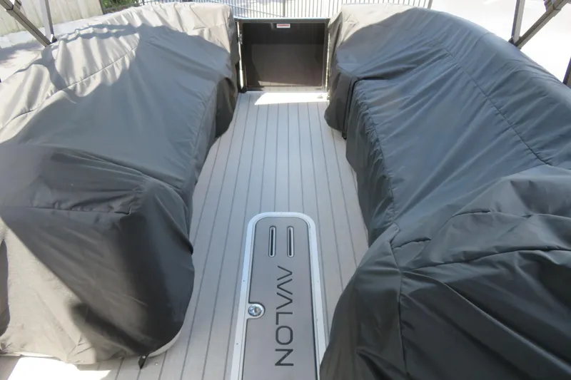 Slide: The Image of 2027 Avalon LSZ Versatile Rear Bench boat interior with covered seating and sleek flooring. - 42