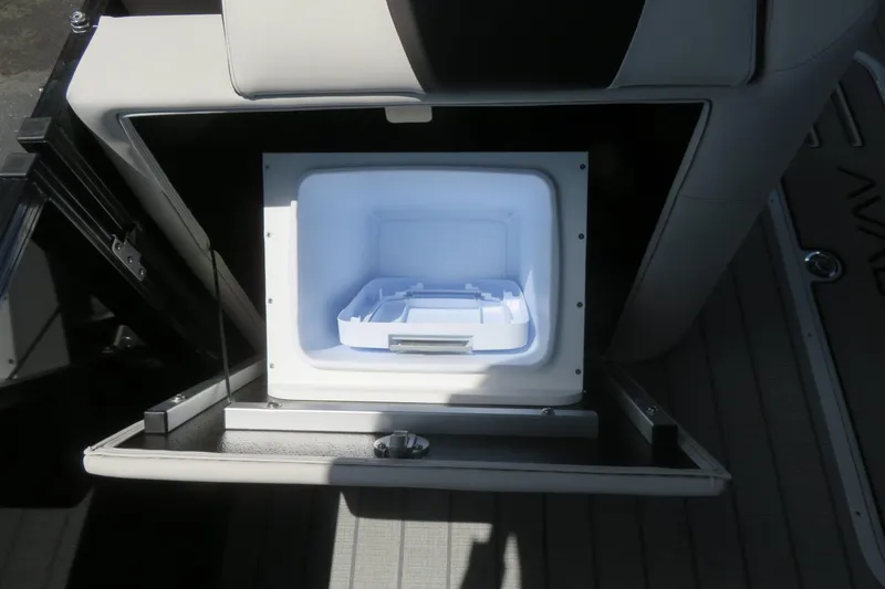Slide: The Image of Open storage compartment in 2027 Avalon LSZ Versatile Rear Bench boat, showcasing interior space. - 32