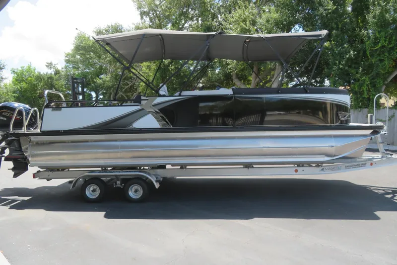 Slide: The Image of 2027 Avalon LSZ Versatile Rear Bench pontoon boat on trailer, featuring sleek design and canopy. - 5