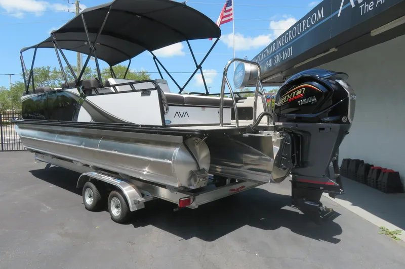 Slide: The Image of 2027 Avalon LSZ Versatile Rear Bench boat on trailer with Yamaha engine. - 2