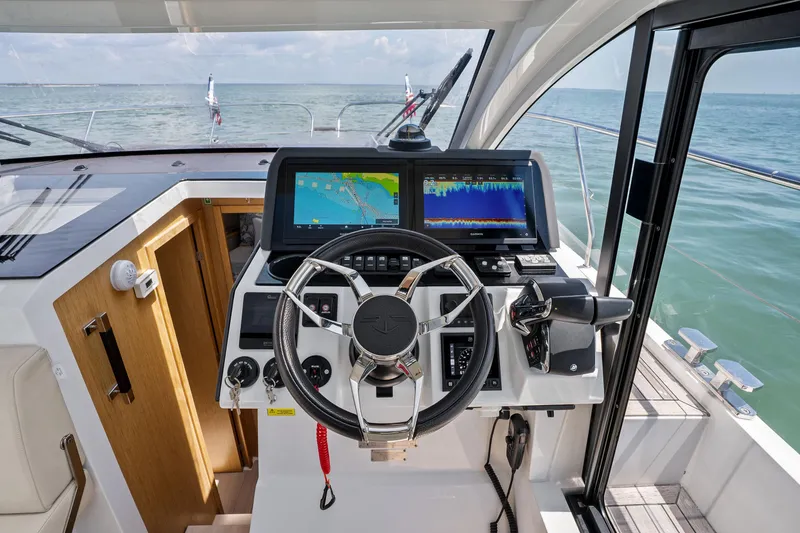 Slide: The Image of Helm of 2023 Sealine C335V yacht with advanced navigation displays and steering wheel. - 17