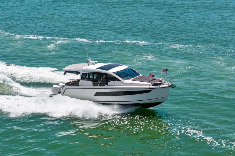 Slide: The Image of 2023 Sealine C335V yacht cruising on open water, showcasing sleek design and performance. - 7
