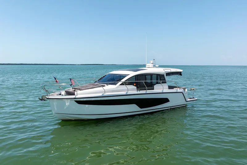 The Image of 2023 Sealine C335V yacht on calm blue waters under clear sky. - 0