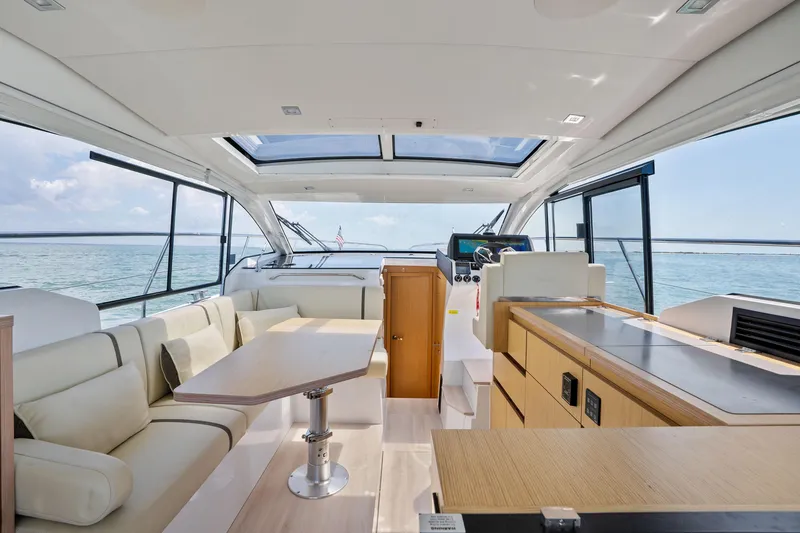 Slide: The Image of Luxurious interior of 2023 Sealine C335V yacht with panoramic windows and modern furnishings. - 13