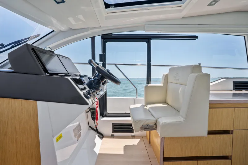 Slide: The Image of Interior of 2023 Sealine C335V yacht, featuring modern helm and seating with ocean view. - 18