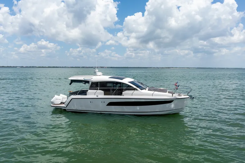 Slide: The Image of 2023 Sealine C335V yacht on calm sea under a partly cloudy sky. - 5