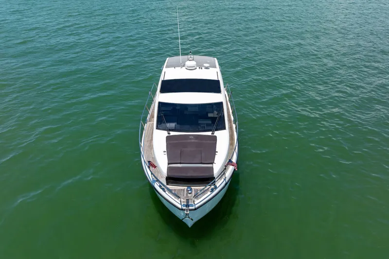 Slide: The Image of 2023 Sealine C335V yacht on calm green water, aerial view. - 6