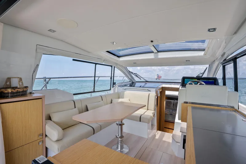 Slide: The Image of Interior of 2023 Sealine C335V yacht with modern seating and ocean view. - 14