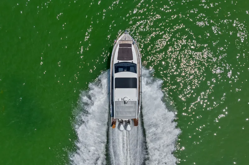 Slide: The Image of Aerial view of 2023 Sealine C335V yacht cruising on vibrant green water. - 8