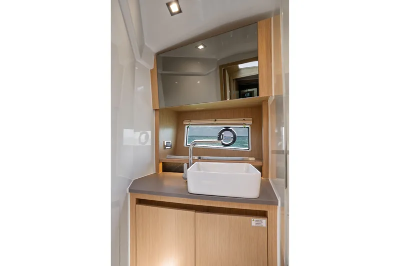 Slide: The Image of Modern bathroom interior of 2023 Sealine C335V yacht with sleek sink and wooden cabinetry. - 21