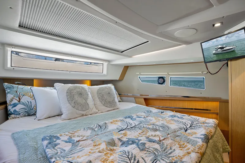 Slide: The Image of Luxurious cabin interior of 2023 Sealine C335V yacht with cozy bedding and scenic window views. - 19